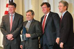Volunteer of the Year finalists the Rev. Dr. Robert Odierna, center left, and David Heath, center right, pose at the Greater Nashua Chamsber of Commerce Eminence Awards luncheon at the Crowne Plaza Hotel in Nashua on Wednesday with Jim Conway, left, treasurer of Conway Arena, and John Fouhy of Comcast, director of government and community relations for northern New England.